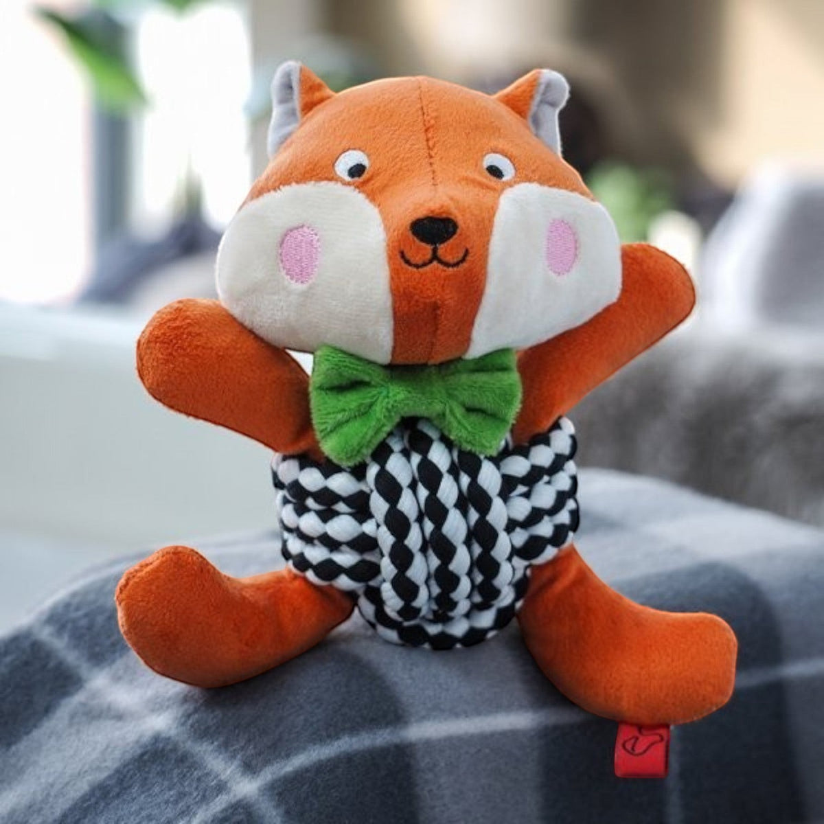 BATA LTD Zoon Foxy Playpal dog toy with plush orange fox head, green bowtie, and black and white rope ball body.