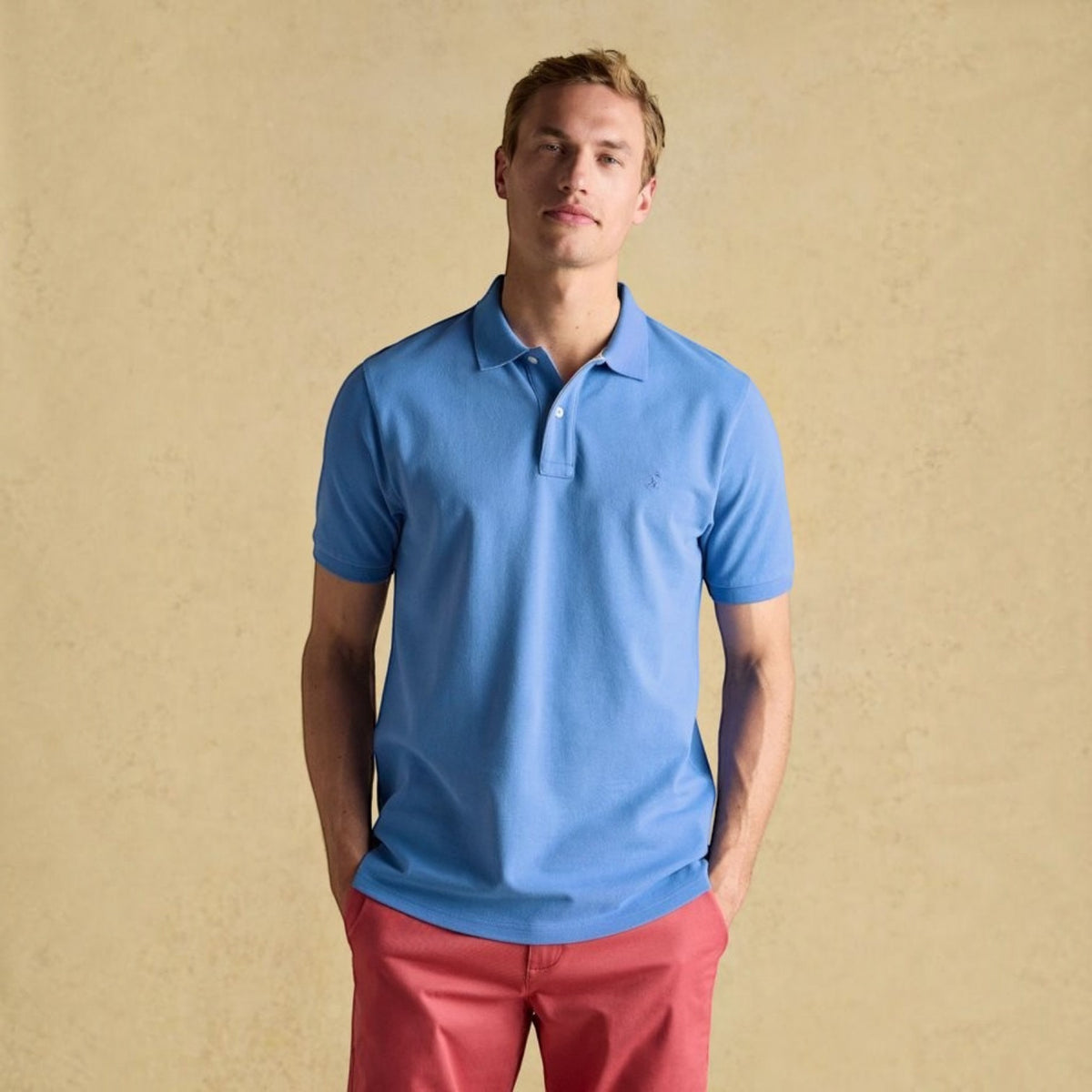 BATA LTD Joules Woody blue cotton pique polo shirt with short sleeves and embroidered hare logo on the chest.