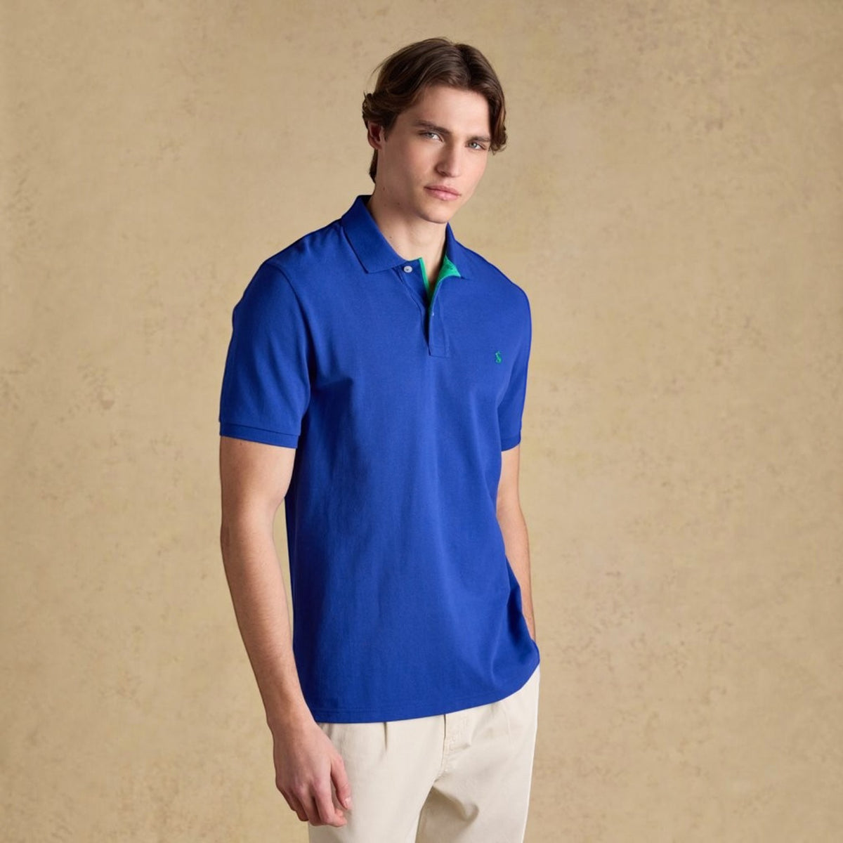BATA LTD Joules Woody blue cotton pique polo shirt with green undercollar and embroidered hare logo on chest
