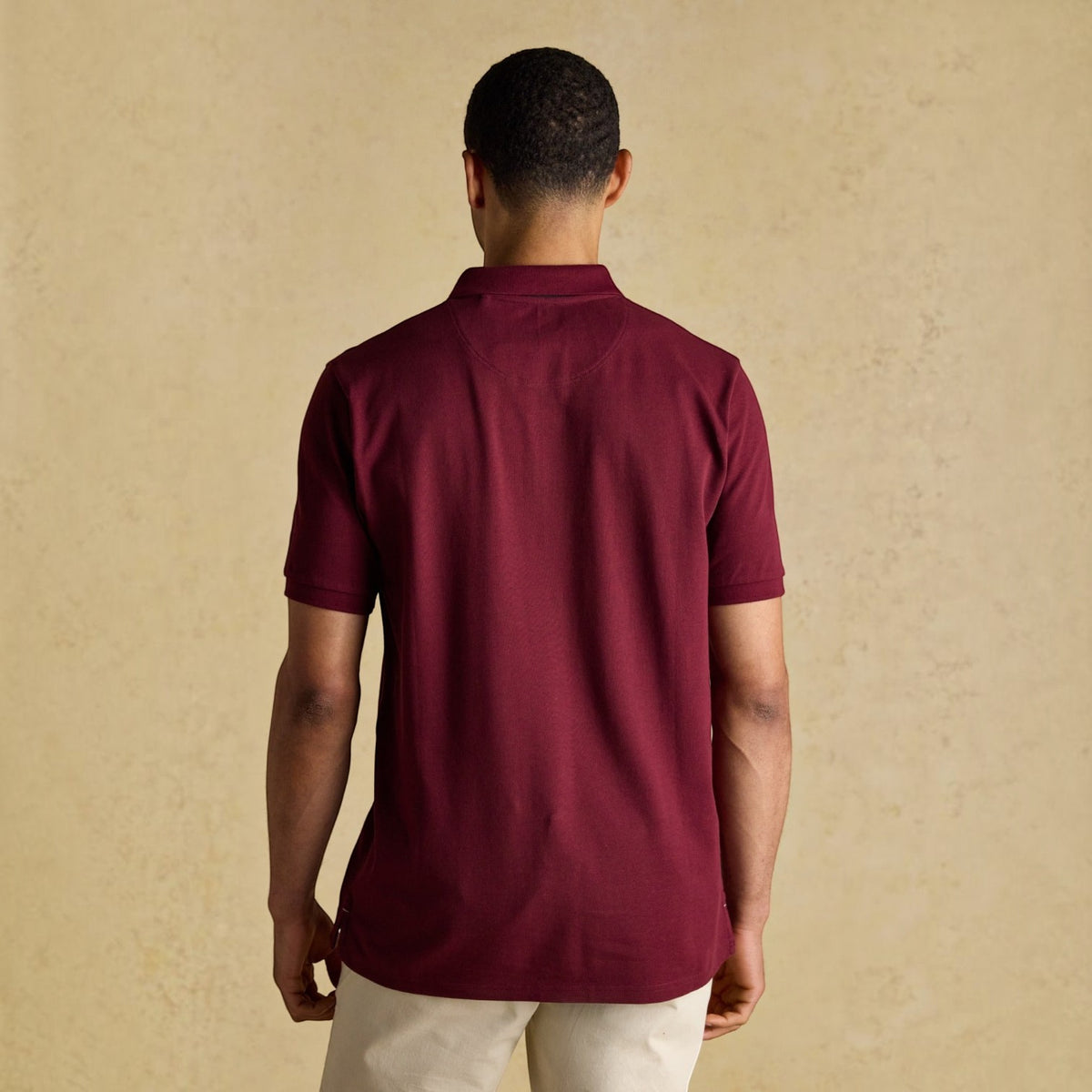 BATA LTD Joules Woody men's burgundy cotton pique polo shirt viewed from the back on a model