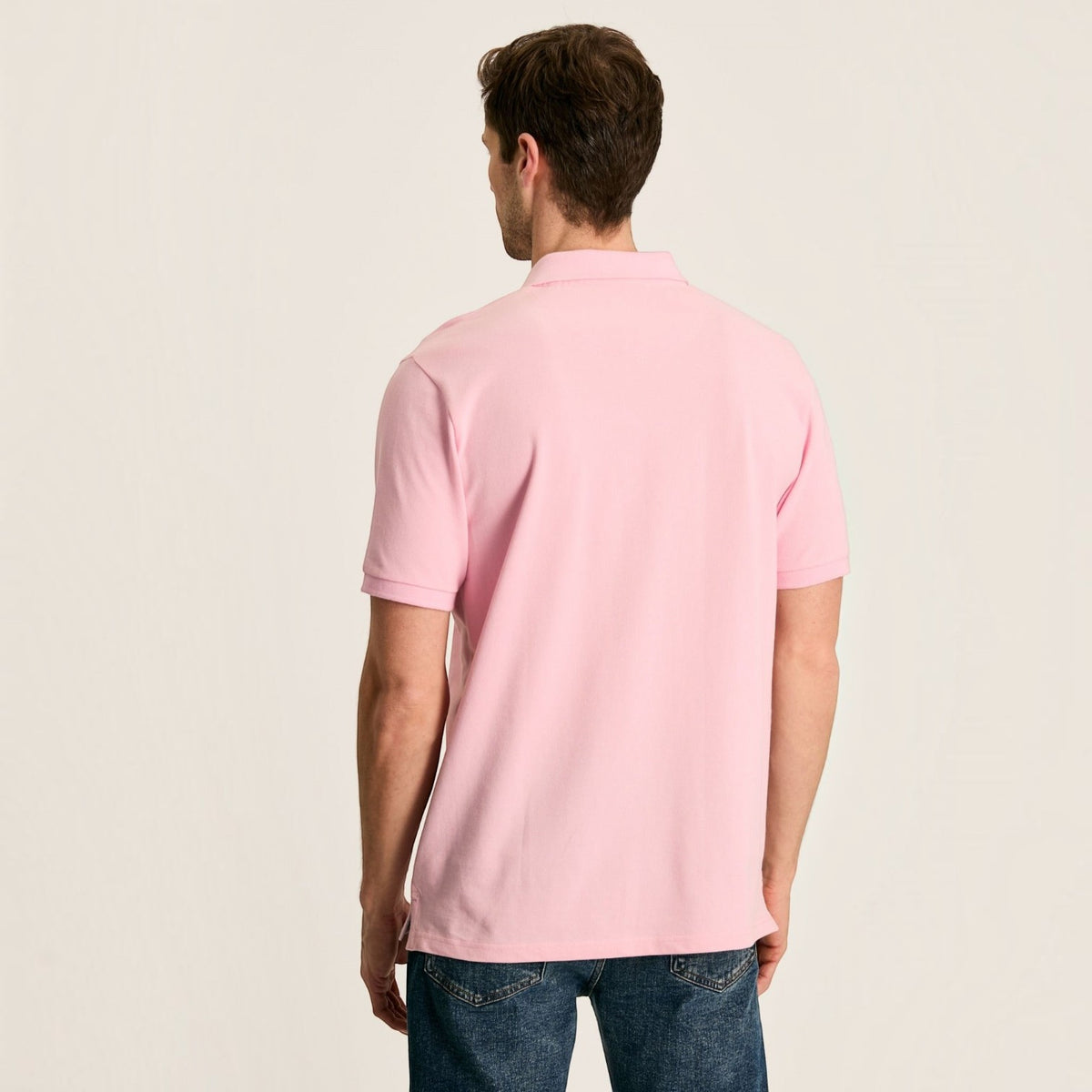 BATA LTD Joules Woody pink cotton pique polo shirt worn by a man, back view showing short sleeves and classic fit