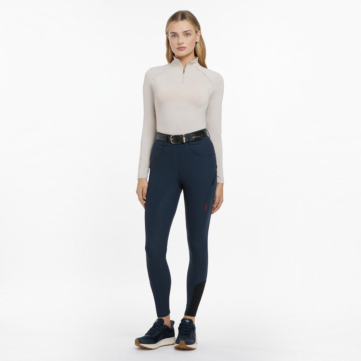BATA LTD LeMieux Amy breggings in navy with silicone seat, phone pocket, and tapered fit worn by a female model.